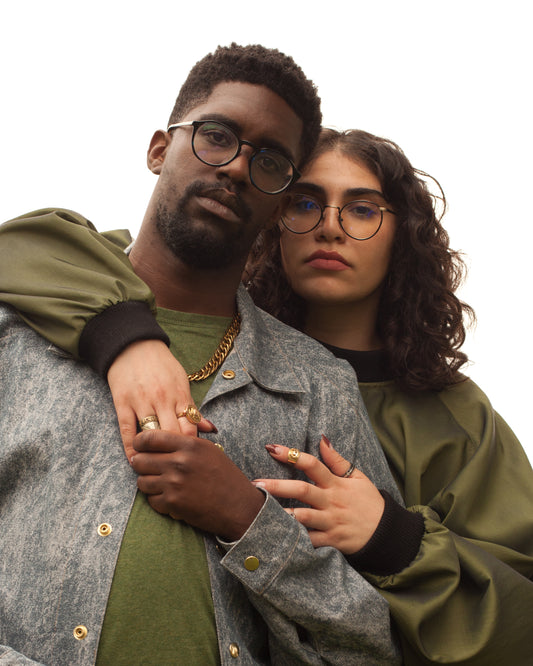 Picture of two models embracing, one is wearing the House of Glass Cardi B-omber Jacket and the other is wearing the House of Glass Olive Myself Sweater