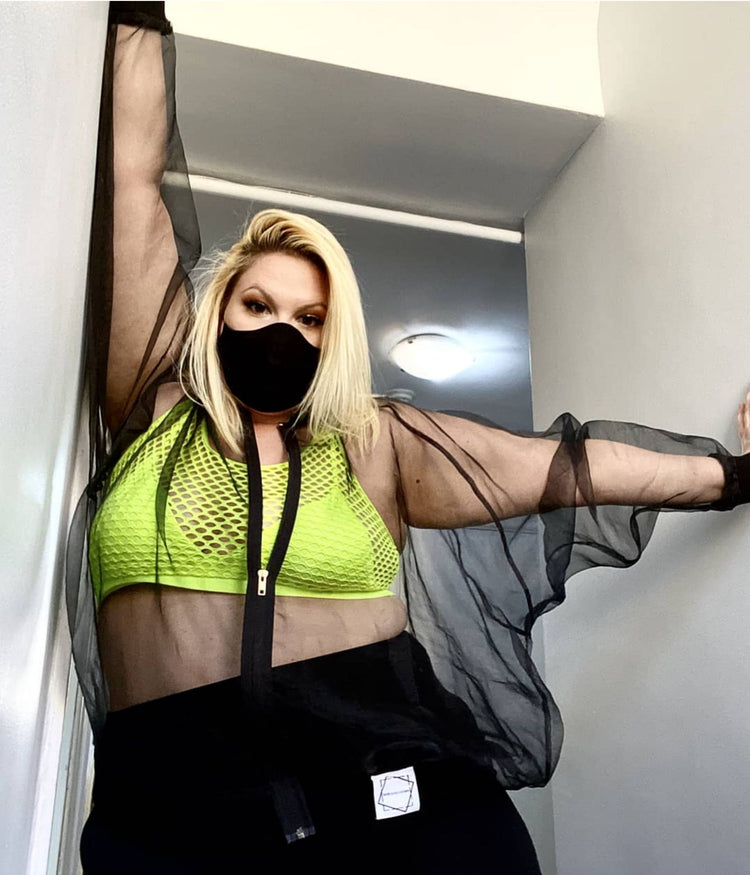 picture of plus size model wearing house of glass black sick organza bomber jacket black mask and neon green bra
