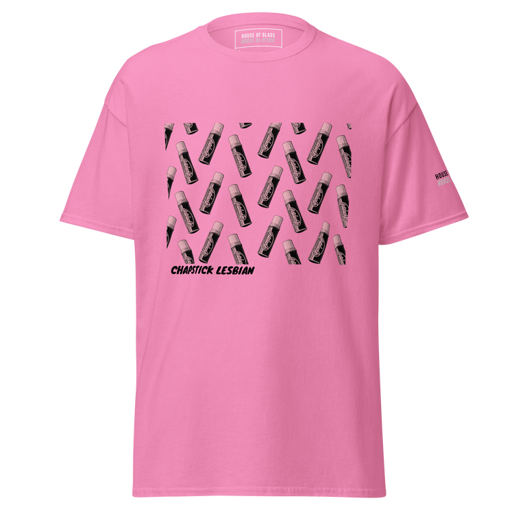 Ghost-style front facing T-shirt mockup of a pink short sleeve t-shirt from the House of Glass Pride Collection. The design features a recurring pattern of a black and white ChapStick on the centre front.