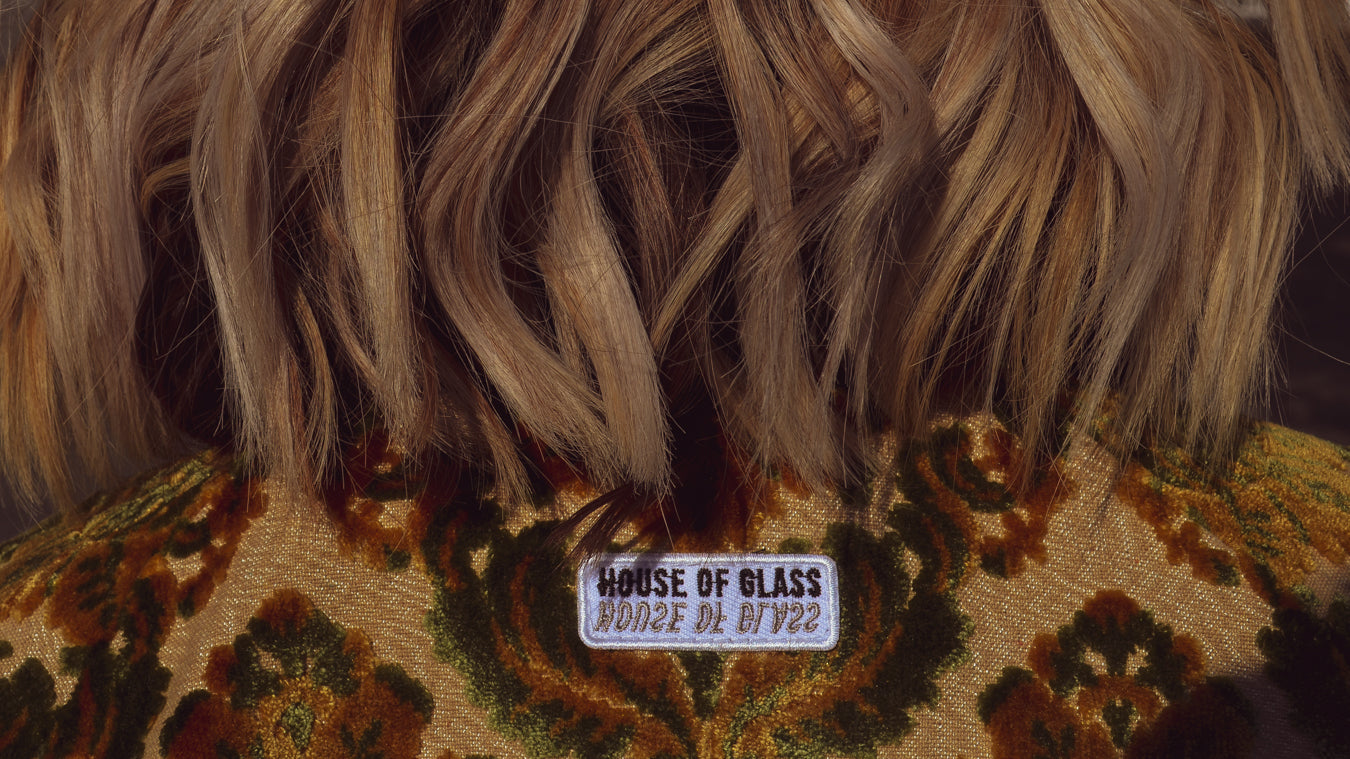 Close up of the House of Glass logo patch on the back of the House of Glass Carpetbag Bomber Jacket