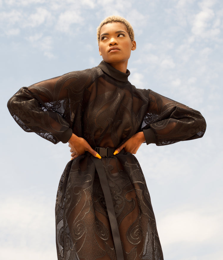 Picture of female model wearing black Hot Mesh Dress with her hands on her hips