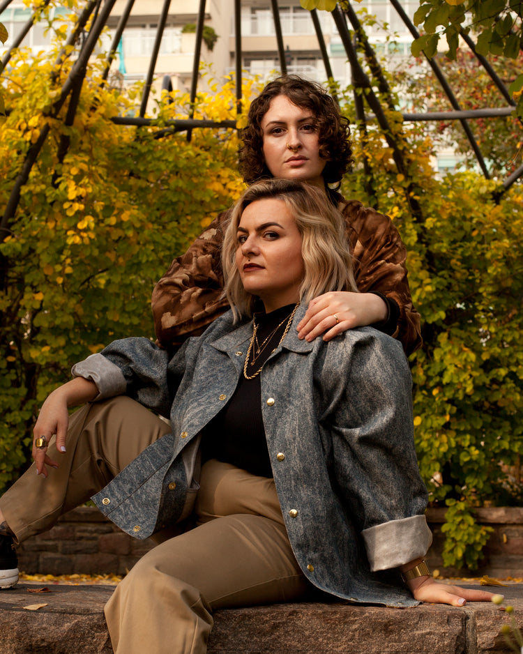 Picture of two models. one is wearing the House of Glass Cardi B-omber Jacket and the other is wearing the House of Glass Dustbowl Sweater