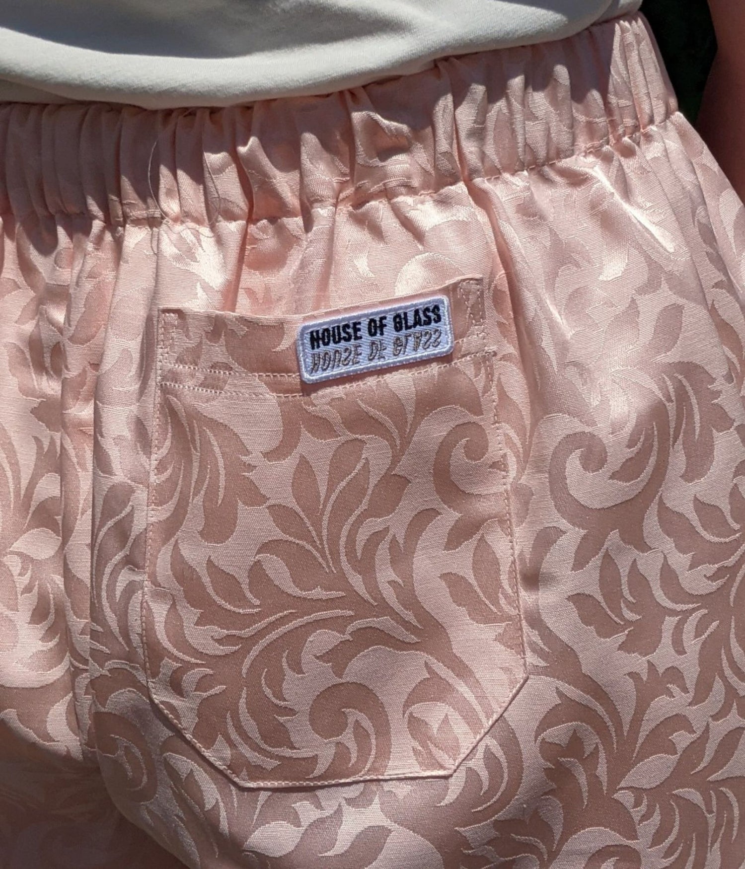close up picture of Aramis shorts and House of Glass logo