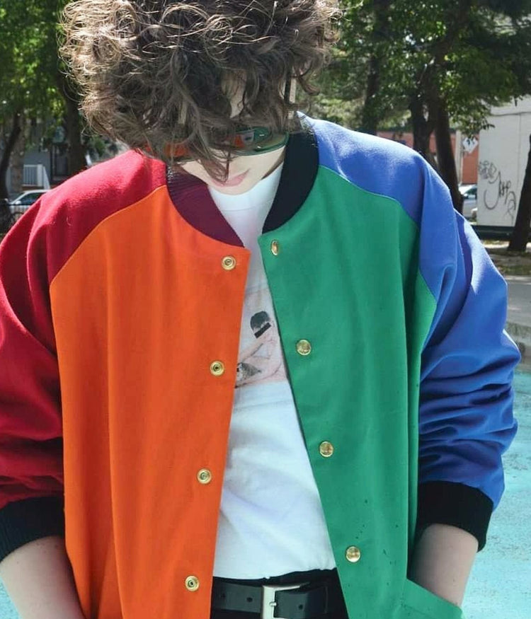 picture of non binary model wearing St Peter Bomber Jacket posing in swimming pool