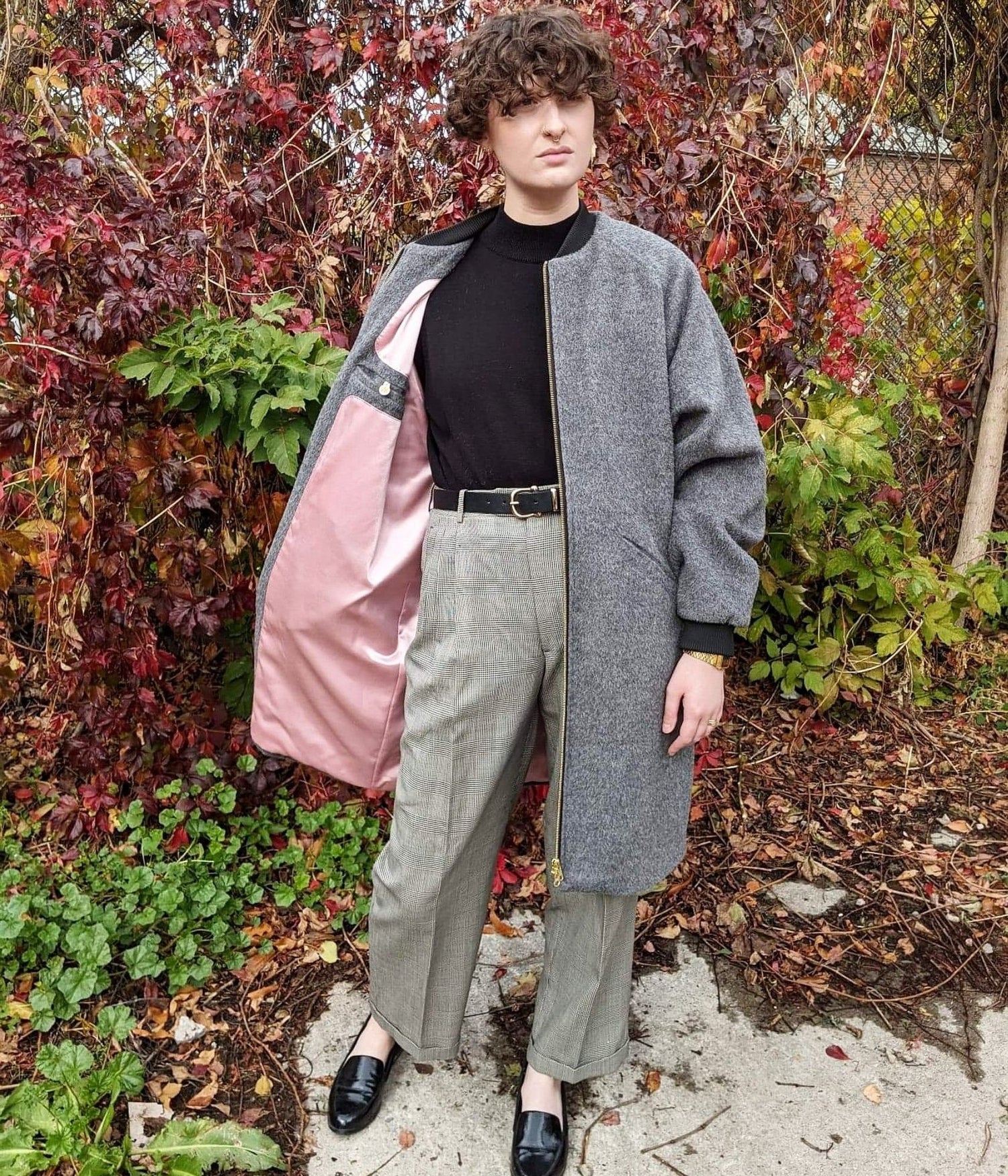 picture of non binary model wearing grey luxe winter coat and showing pink satin lining