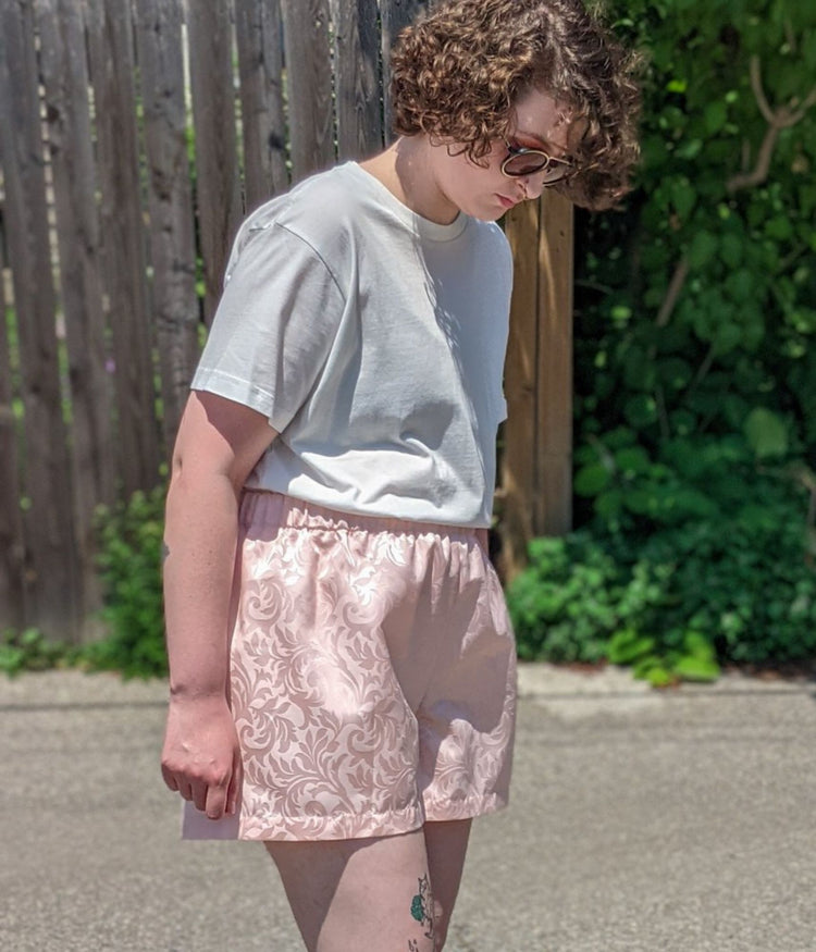 picture of non binary model wearing white t-shirt and Aramis Shorts