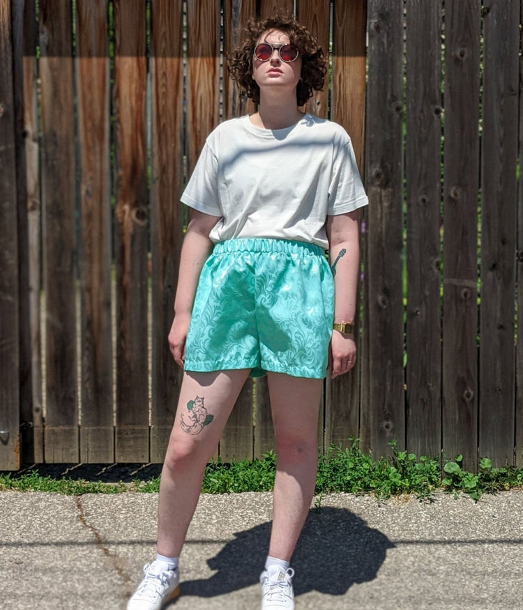 picture of non binary model wearing white t-shirt and Athos Shorts