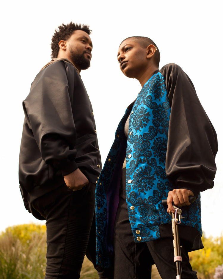 picture of two models walking towards each other wearing House of Glass bomber jackets